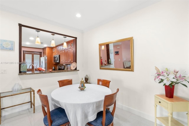 dining room featuring crown molding and sink