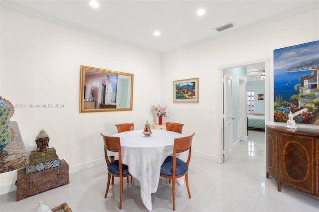 dining space with ceiling fan, light tile patterned floors, and ornamental molding