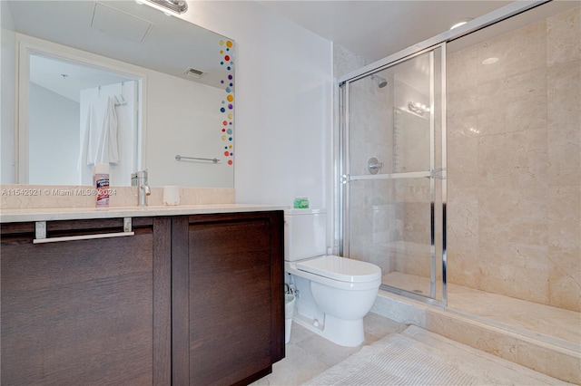 bathroom with vanity, tile flooring, a shower with door, and toilet