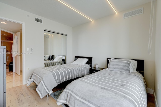 bedroom with a closet and light wood-type flooring