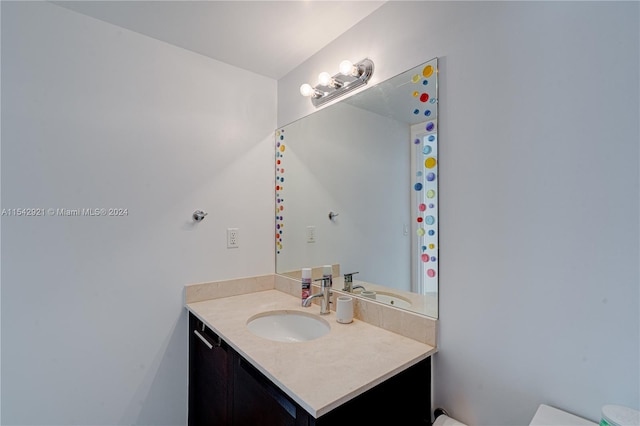 bathroom featuring toilet and vanity