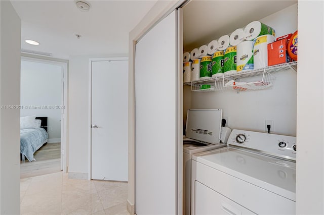 laundry area with light tile flooring, hookup for an electric dryer, and independent washer and dryer