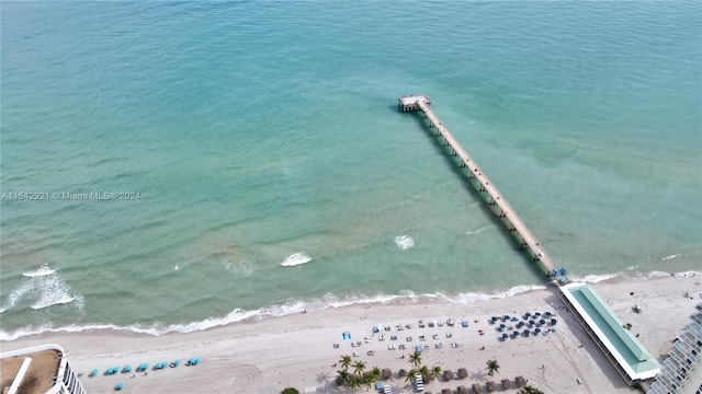 birds eye view of property featuring a water view and a beach view