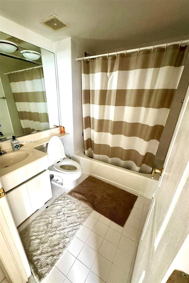 bathroom featuring toilet, large vanity, and tile floors