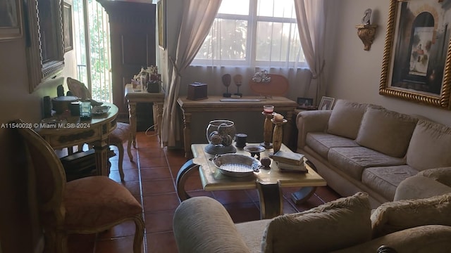 living room with plenty of natural light and dark tile flooring