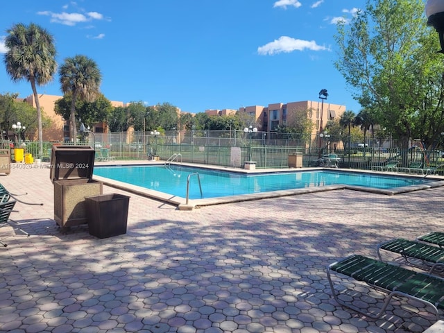 view of swimming pool featuring a patio area