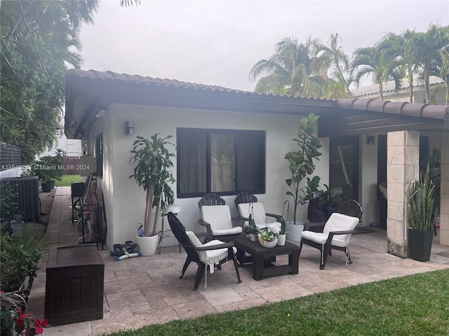 rear view of property featuring a pergola and a patio area