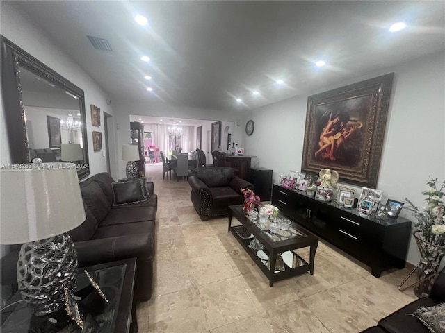 living room featuring light tile floors and a chandelier