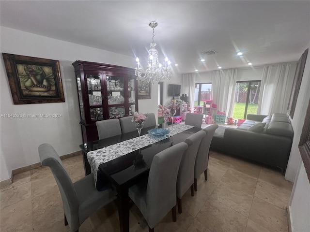 tiled dining area featuring a notable chandelier