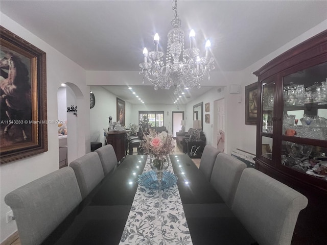 dining area featuring an inviting chandelier and lofted ceiling