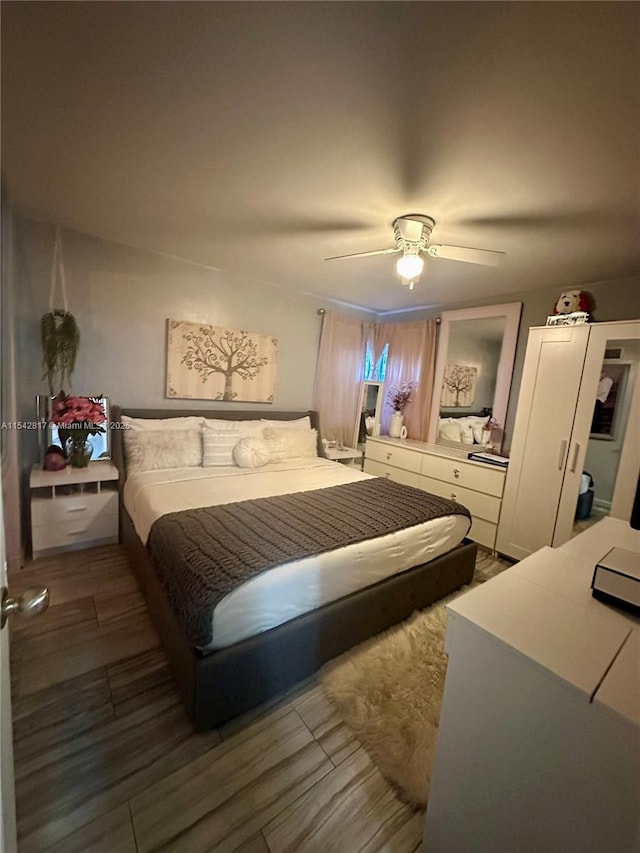 bedroom featuring ceiling fan and wood finished floors