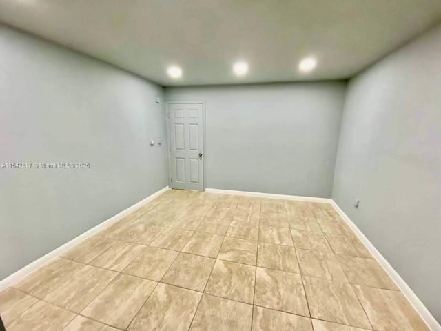 unfurnished room with light tile patterned floors, recessed lighting, and baseboards