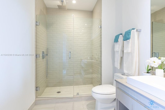 bathroom with a shower with shower door and vanity