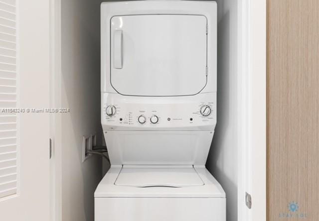 clothes washing area with stacked washer and dryer