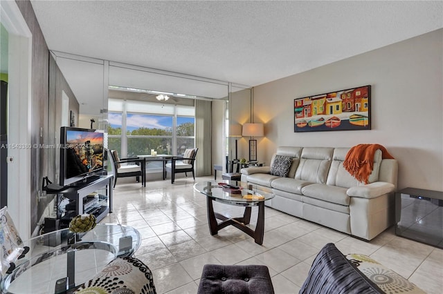 living room featuring expansive windows, a textured ceiling, and light tile patterned floors