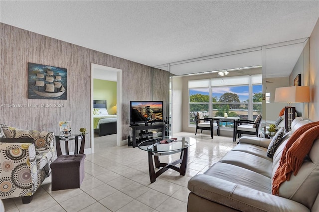 tiled living room featuring a textured ceiling