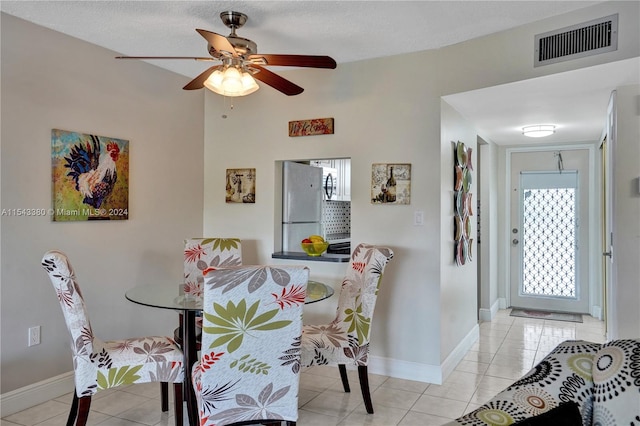 dining room with ceiling fan and light tile patterned flooring