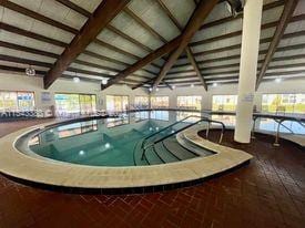 view of pool with a hot tub