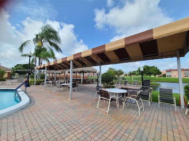 view of patio featuring a water view and a community pool