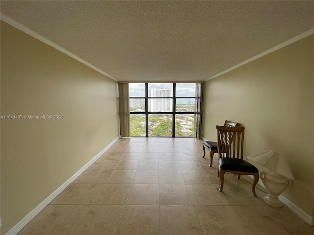 tiled spare room featuring crown molding, a textured ceiling, and a wall of windows