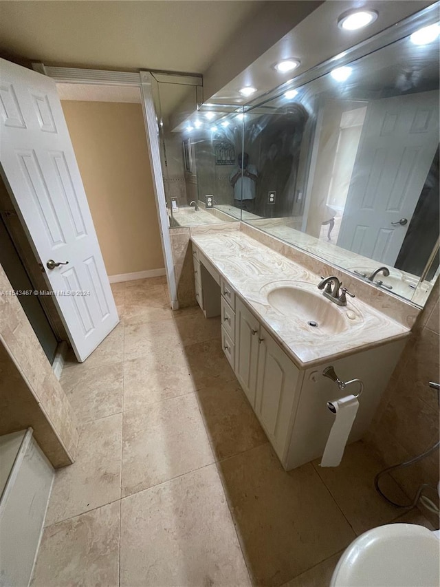 bathroom with walk in shower, tile flooring, and vanity