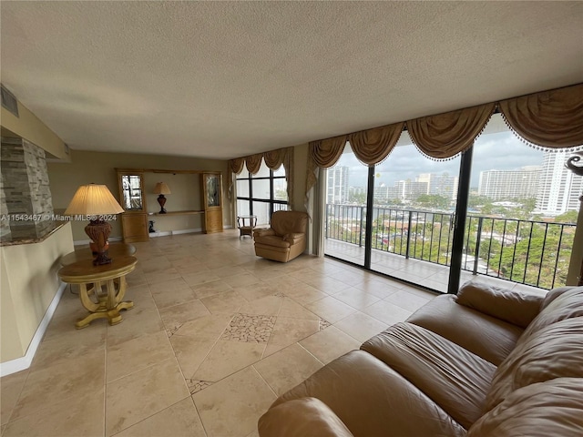 tiled living room featuring a textured ceiling