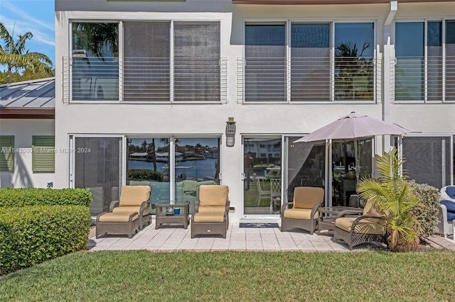 rear view of house with a yard and a patio