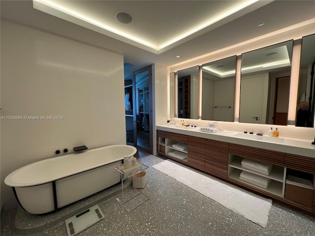 bathroom featuring a tray ceiling and dual vanity