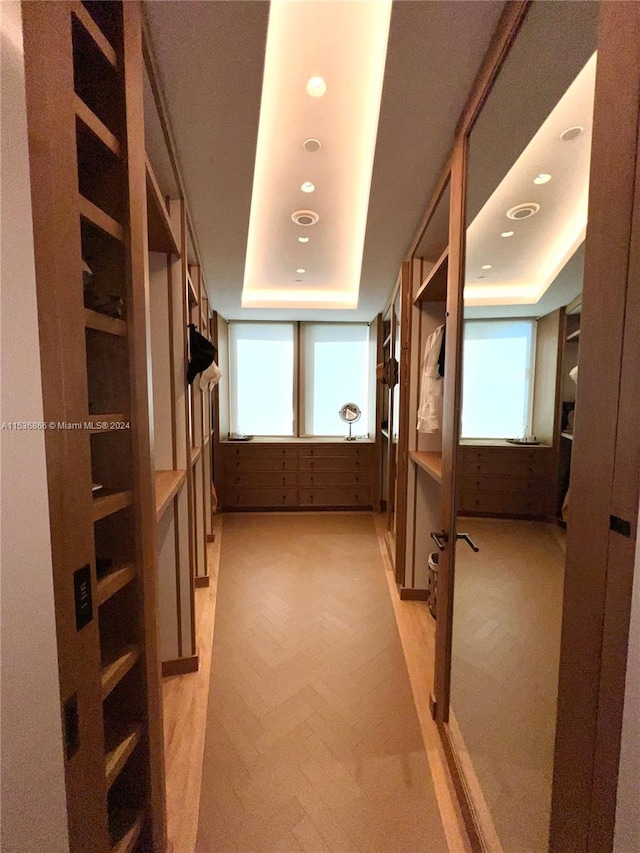 hallway with plenty of natural light and light colored carpet