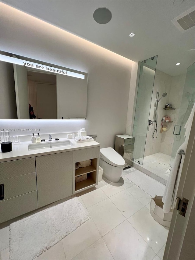 bathroom with walk in shower, toilet, vanity with extensive cabinet space, and tile flooring