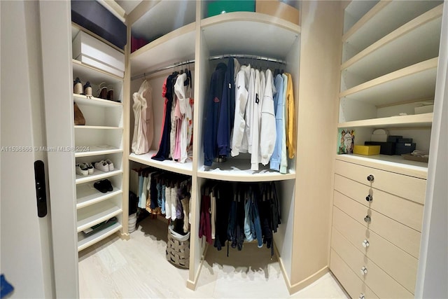 walk in closet featuring light hardwood / wood-style flooring