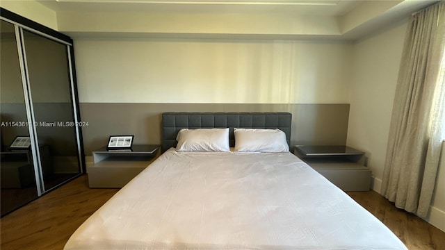 bedroom featuring a closet and dark hardwood / wood-style floors