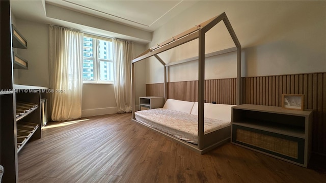 bedroom with dark hardwood / wood-style flooring