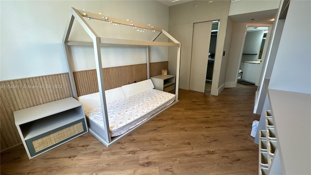 bedroom with radiator and wood-type flooring