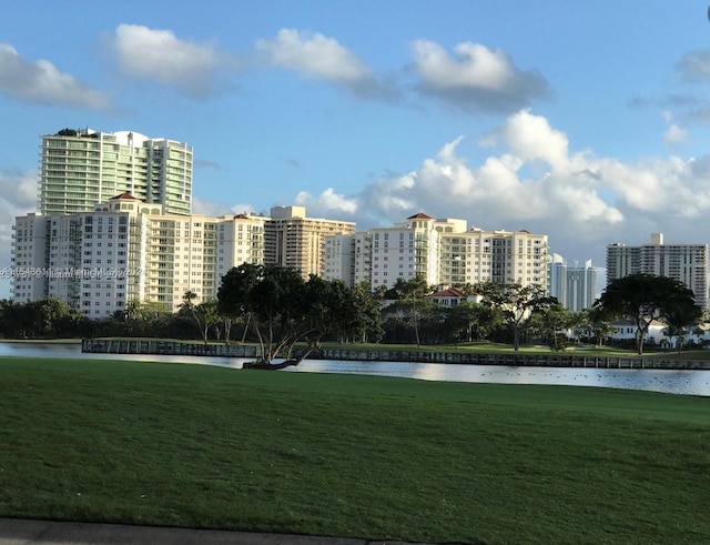 view of home's community featuring a water view and a yard