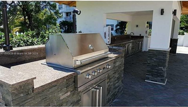 view of patio / terrace featuring a grill, sink, and exterior kitchen