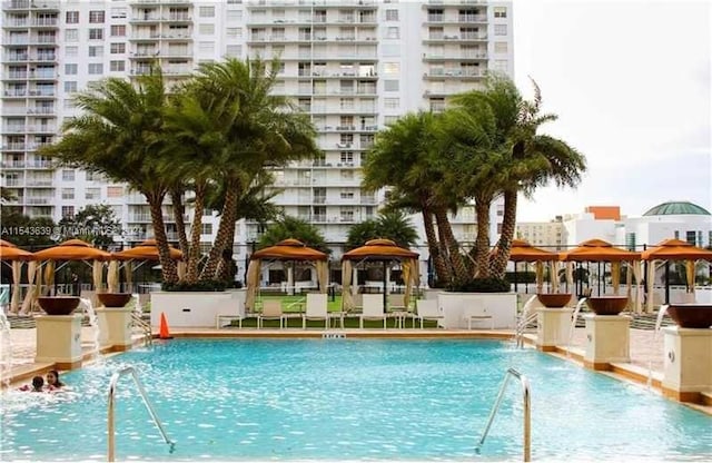 view of swimming pool with a gazebo and pool water feature