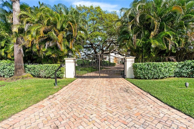 view of gate featuring a lawn