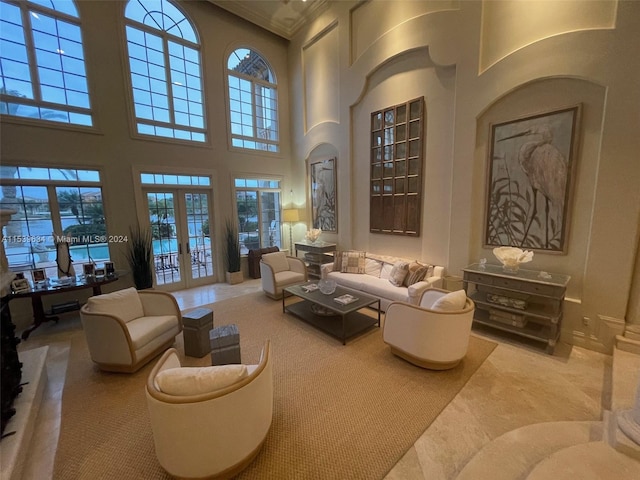 living room with plenty of natural light, a high ceiling, carpet, and french doors