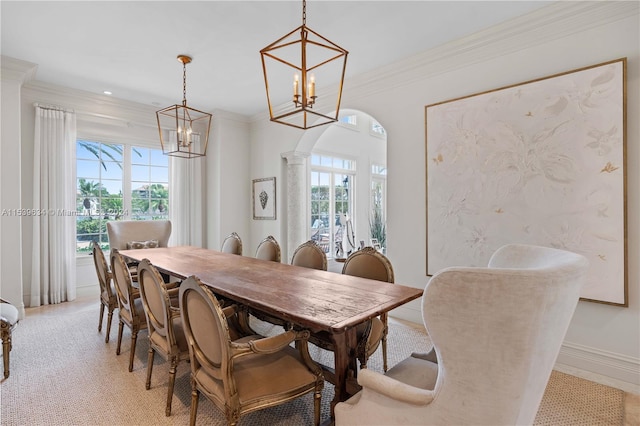 dining area with crown molding, plenty of natural light, a notable chandelier, and light carpet