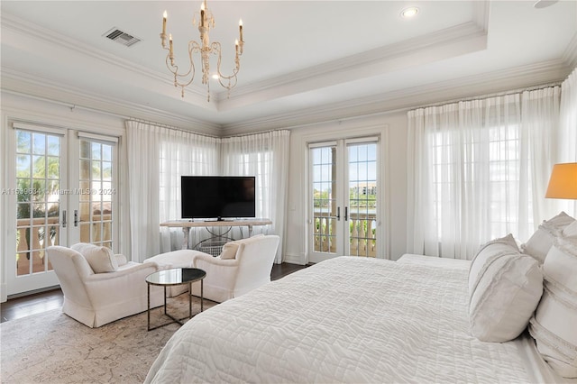 bedroom with multiple windows, french doors, and access to exterior