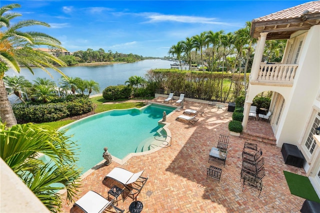 view of pool featuring a patio area and a water view