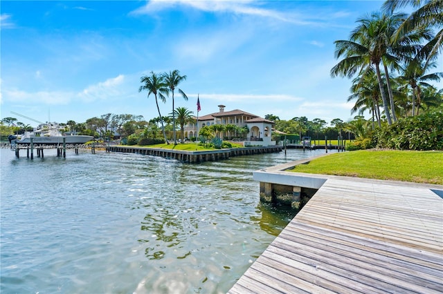 dock area with a yard and a water view