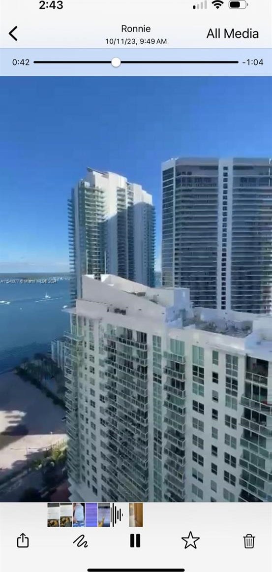 drone / aerial view featuring a water view and a view of city