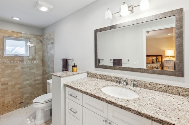 bathroom featuring a shower with door, vanity, tile patterned floors, and toilet