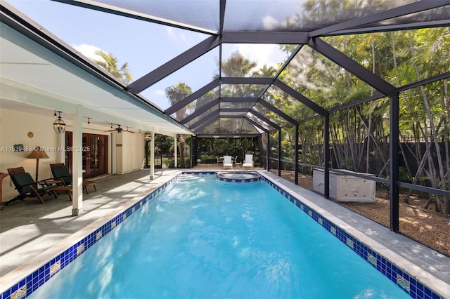 view of pool featuring french doors, a patio area, a lanai, an in ground hot tub, and ceiling fan