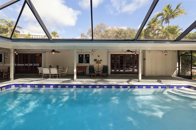 view of swimming pool featuring a patio area, ceiling fan, and french doors