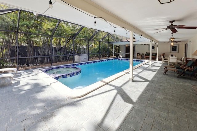 view of swimming pool with an in ground hot tub, ceiling fan, glass enclosure, and a patio