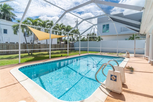 view of swimming pool featuring a yard, glass enclosure, and a patio