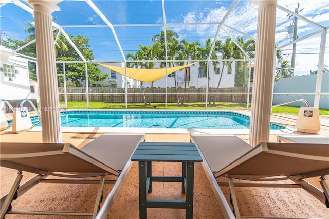 view of pool with a patio area and a lanai